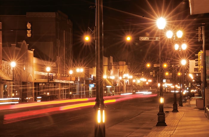 Downtown main street of Liberal, Kansas sports new streetlights with old-time character, but which pour light out in all directions and up into the sky. With no shielding the exposed globes cause much glare that makes seeing difficult. Photo by Jim Richardson.