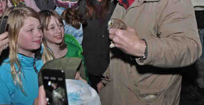 Children gather around a birding expert during a "Owl Branding & Stargazing" event at the Headlands International Dark Sky Park in Michigan.