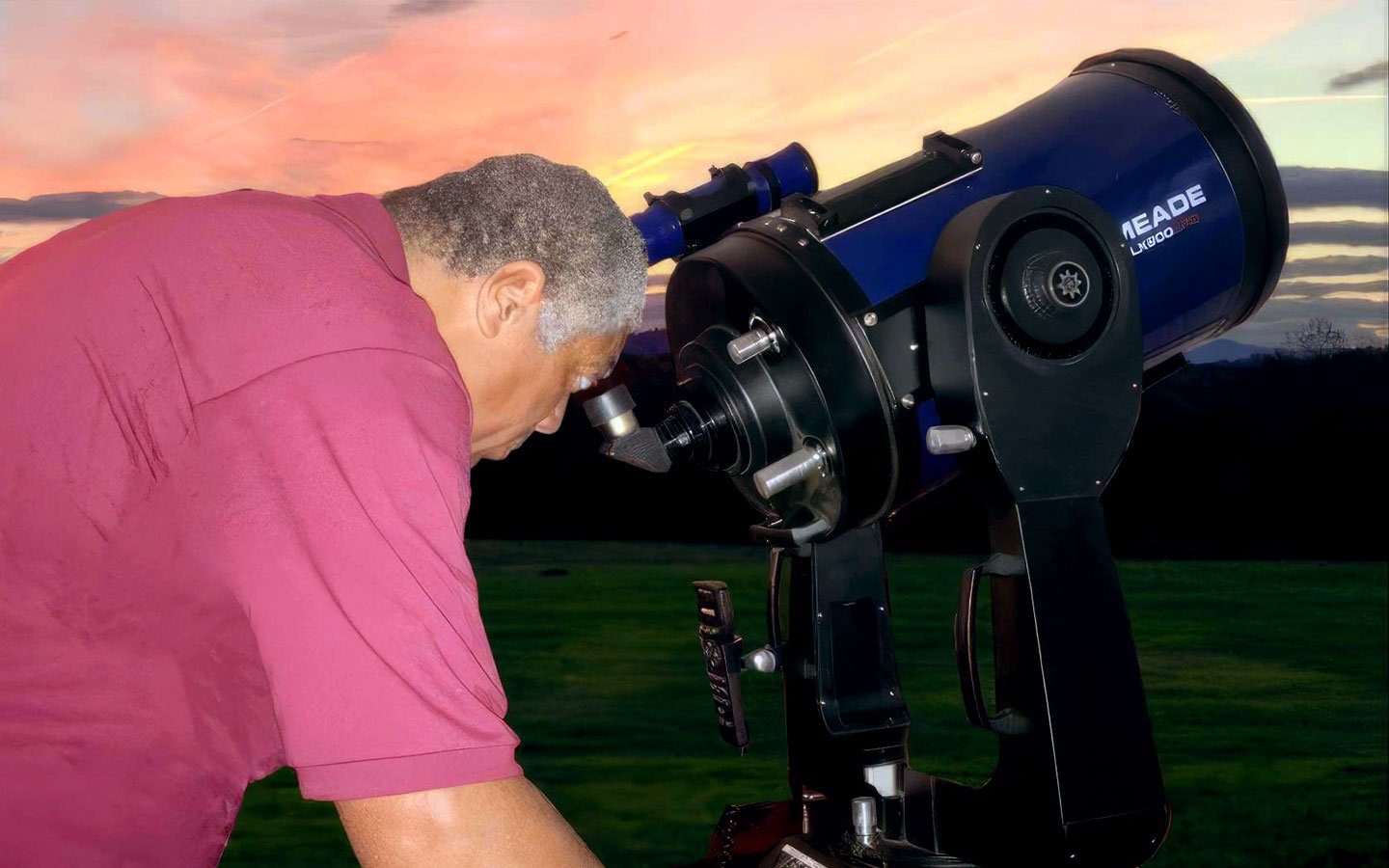 IDA Advocate Michael Lewis looking through a telescope.