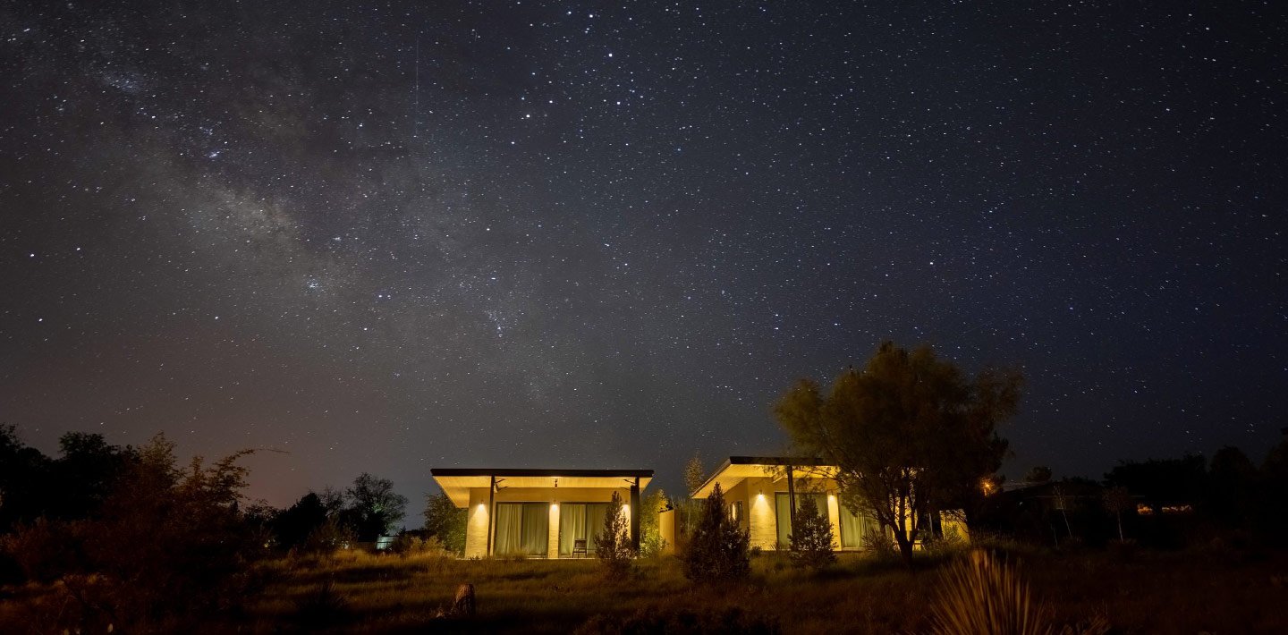 Home with dark-sky friendly lighting beneath a starry sky