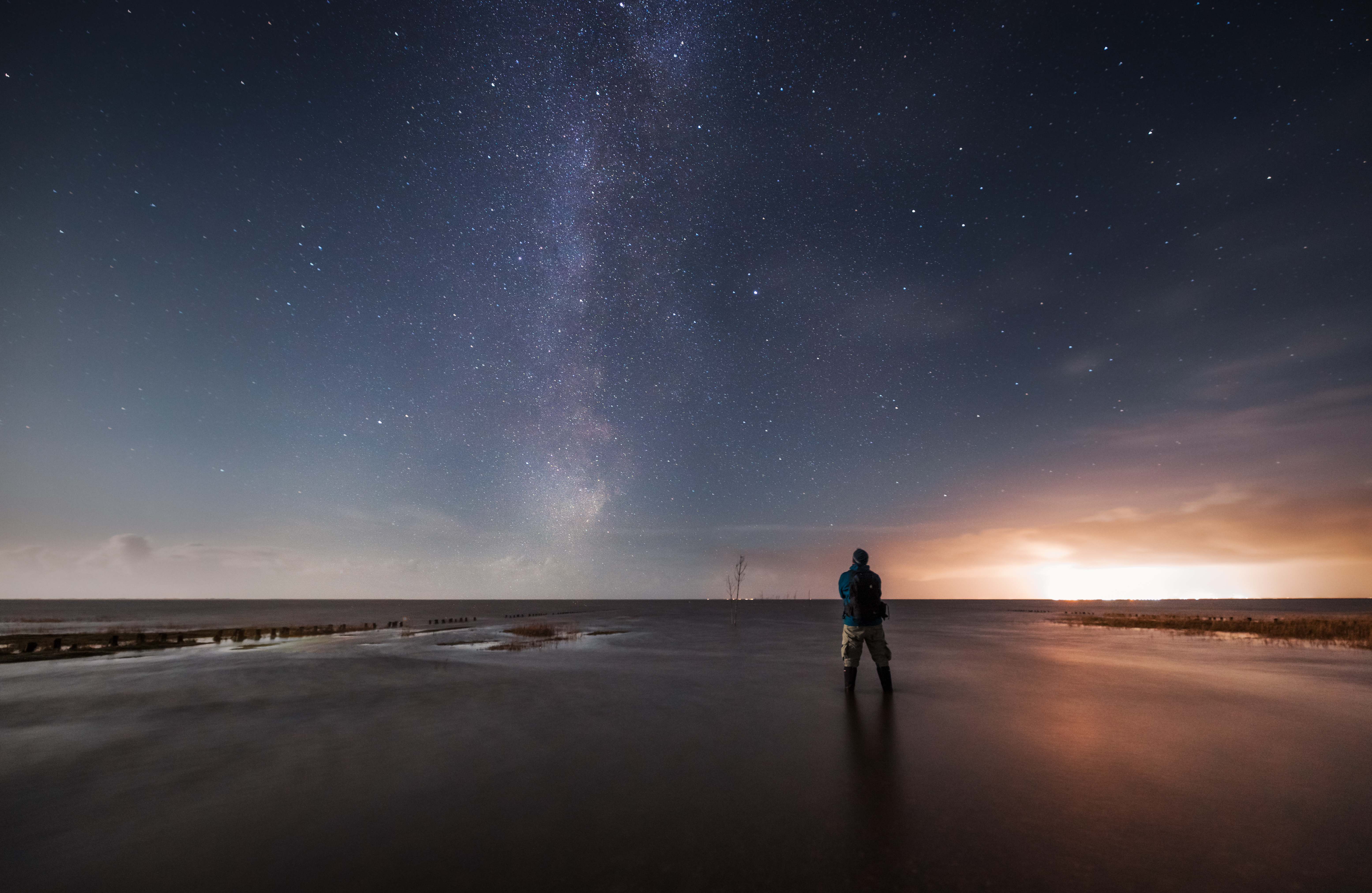 A star-filled night sky and Milky Way over the Wadden Sea.