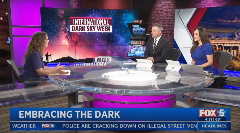 A DarkSky Advocate presents information to two newscasters.