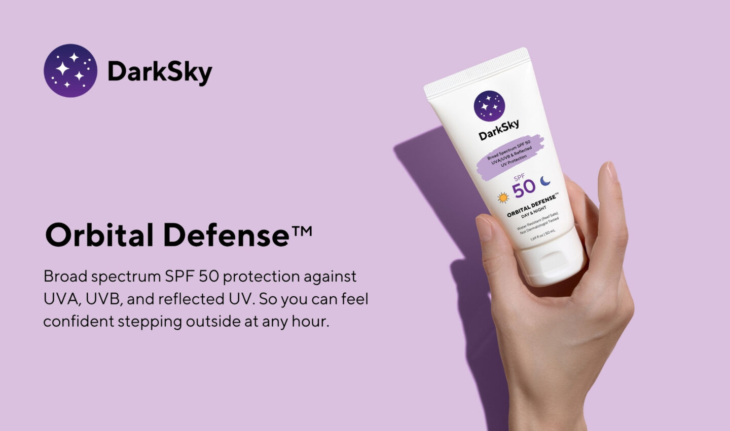 Hand holding sunscreen bottle that is branded with DarkSky colours.