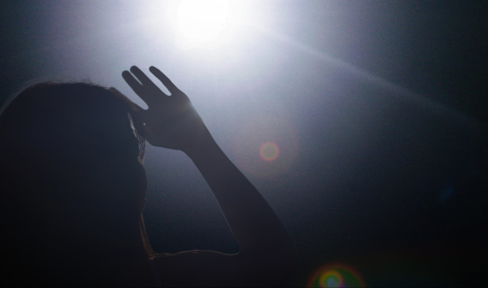 Woman blinded by glare from light at night.