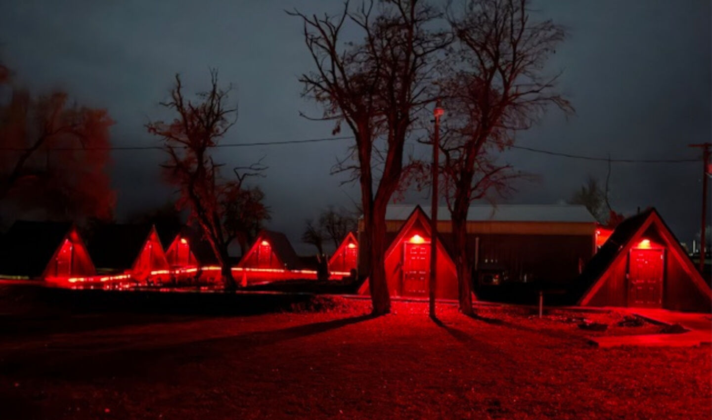 View of triangle shaped cottages lit with red lighting.