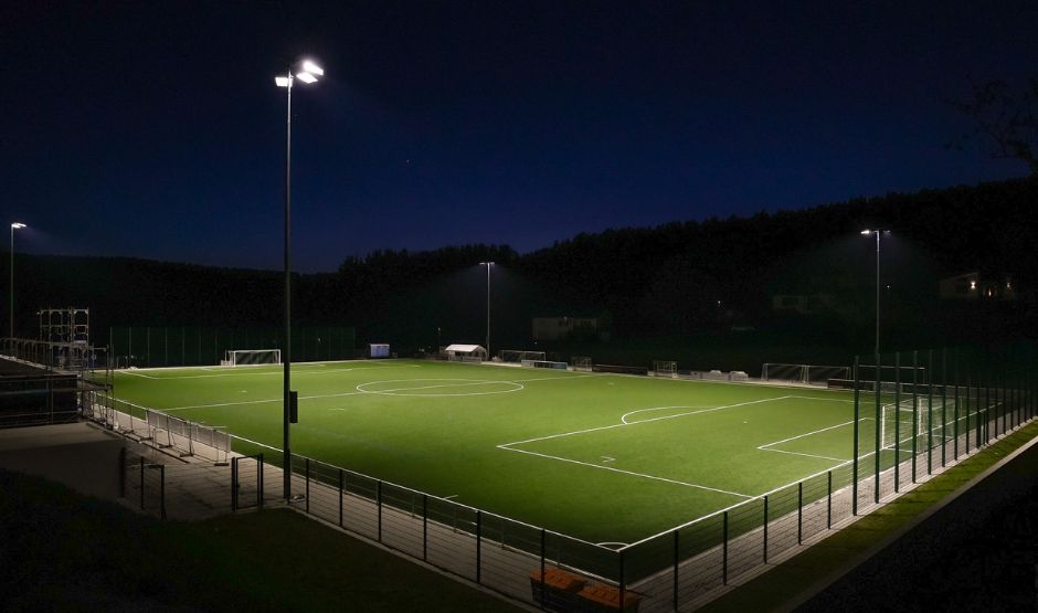 An illuminated soccer field at night.